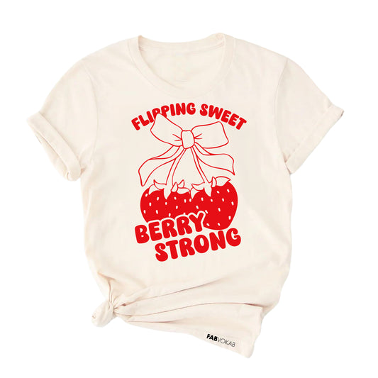Off-white_t-shirt_with_red_strawberry_bow_graphic_and_text_that_says_Flipping_Sweet_Berry_Strong_gymnast_shirt_design.